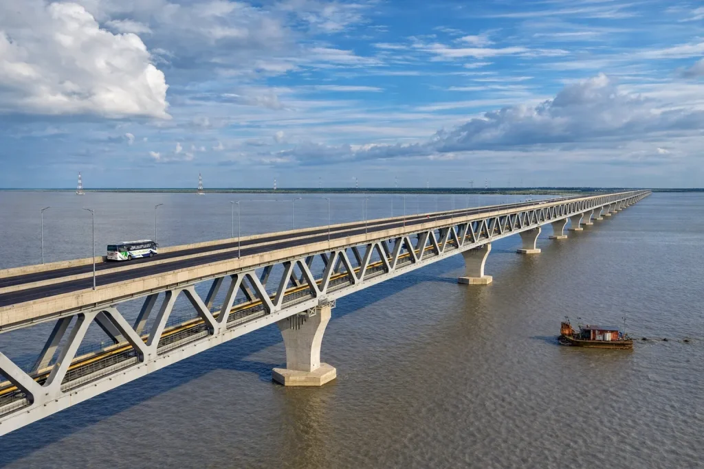 The Padma Bridge over the river, demonstrating the massive infrastructure projects driven by the cement industry in Bangladesh.